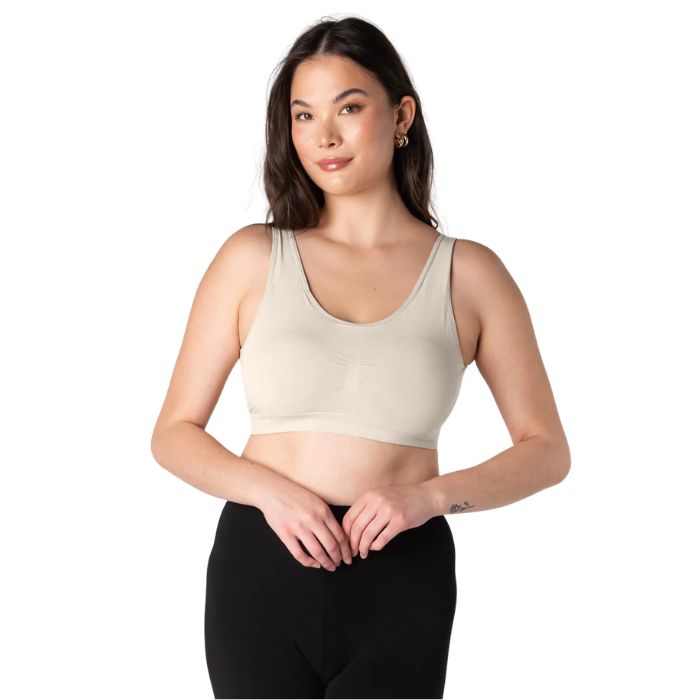 female model wearing cream white essential bralette front view on white background