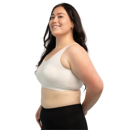female model wearing cream white essential bralette side view on white background