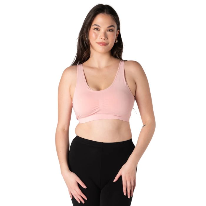 female model wearing pink terrera essential bralette front view on white background
