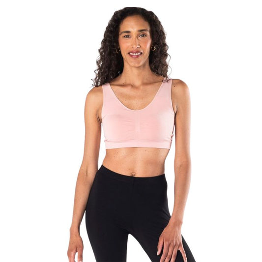 female model wearing pink terrera essential bralette front view on white background