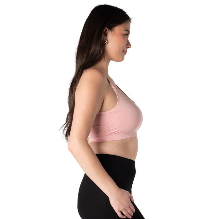 female model wearing pink terrera essential bralette side view on white background