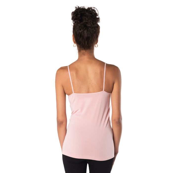 top of female model wearing pink essential cami tank top back view on white background