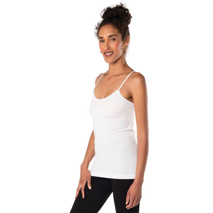 top of female model wearing white essential cami tank top side view on white background