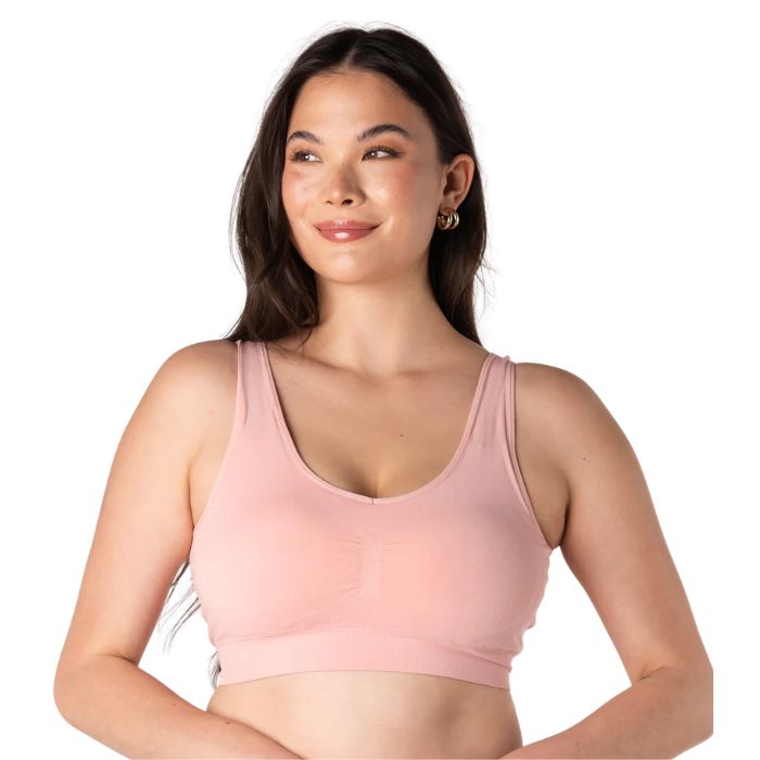 female model wearing pink terrera essential v-neck bralette front view on white background