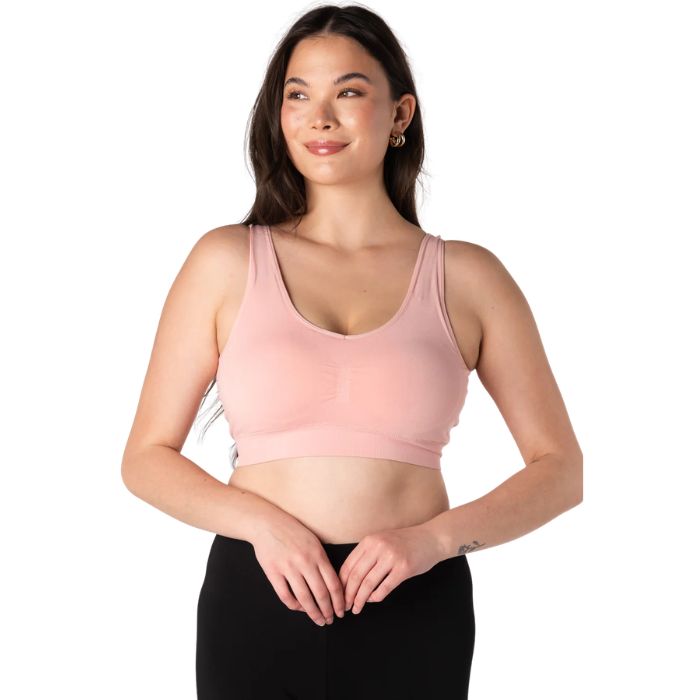 female model wearing pink terrera essential v-neck bralette front view on white background
