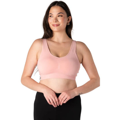 female model wearing pink terrera essential v-neck bralette front view on white background