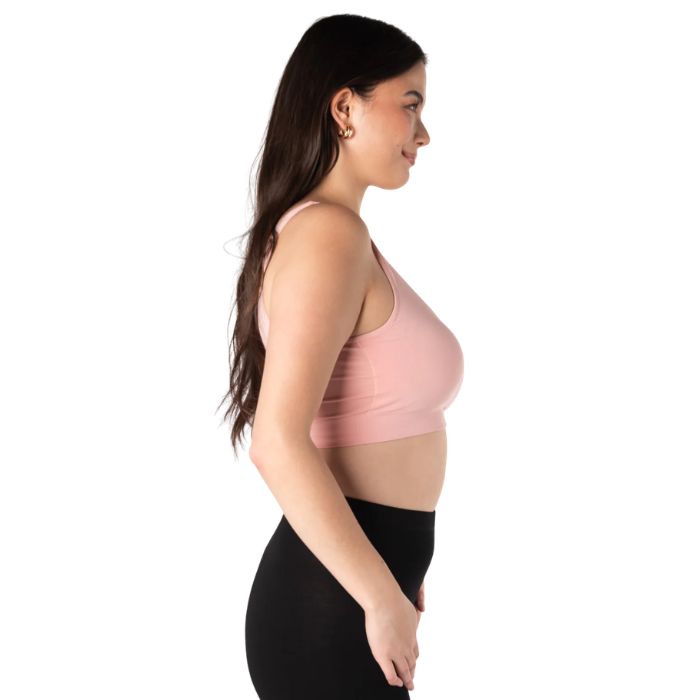 female model wearing pink terrera essential v-neck bralette side view on white background