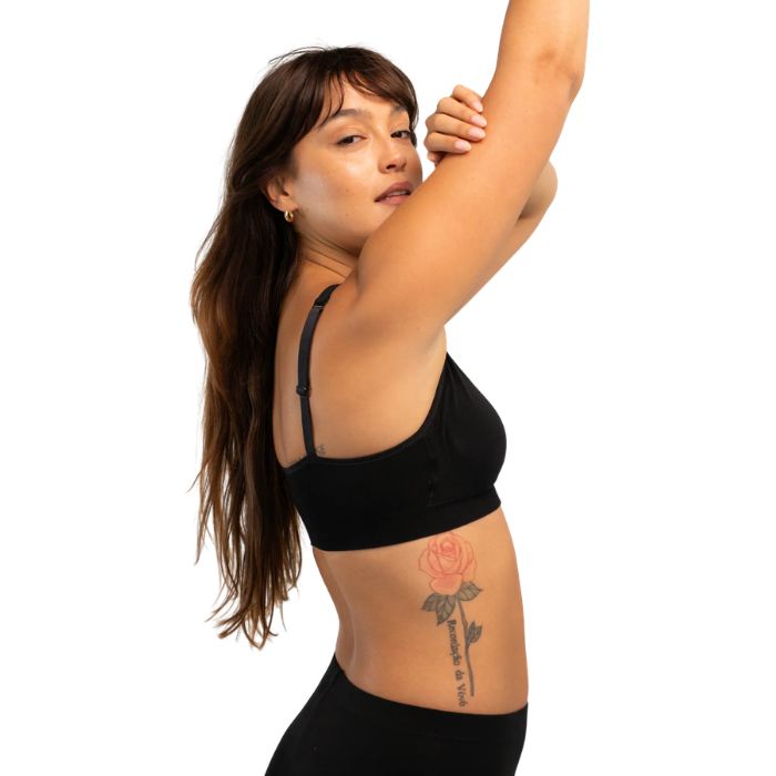female model wearing black everyday adjustable bralette side view on white background