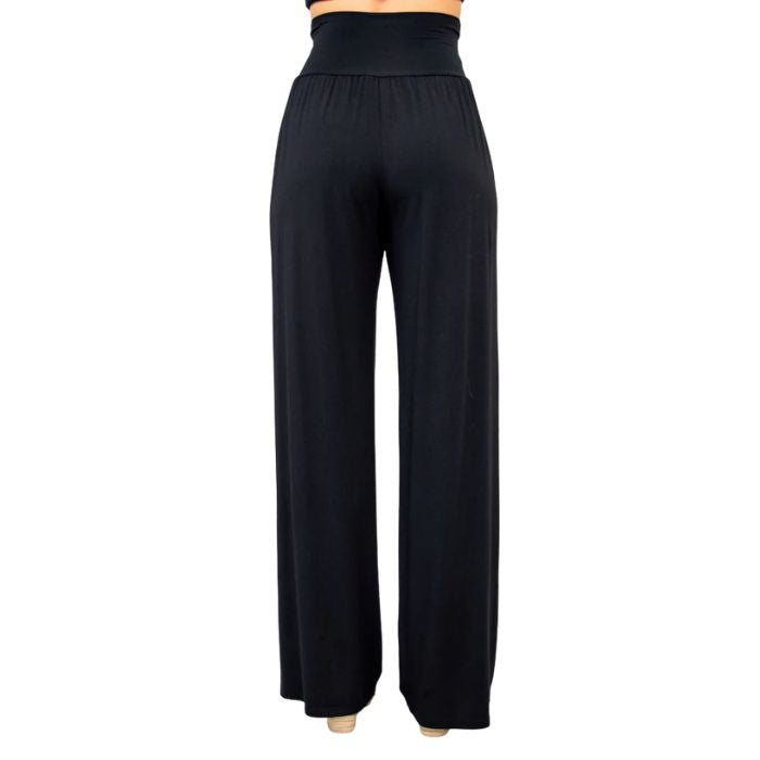 female model wearing black gaylene pants back view on white background