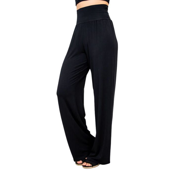female model wearing black gaylene pants side view on white background