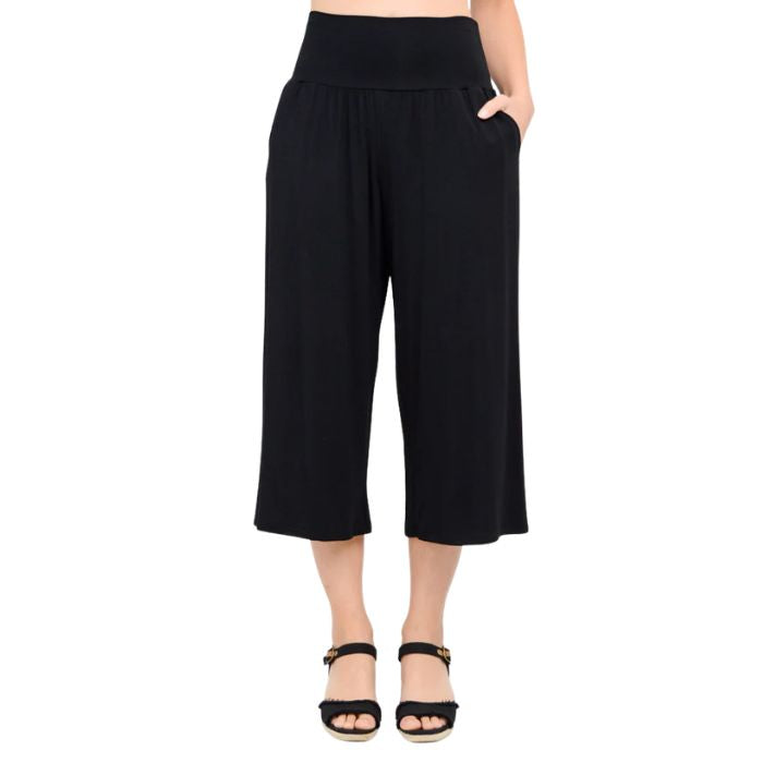 female model wearing black gaylene capri pants front view on white background