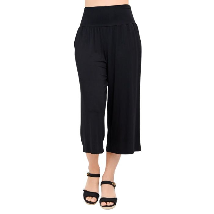 female model wearing black gaylene capri pants front view on white background