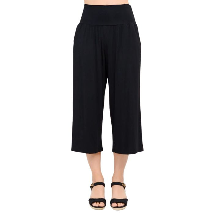 female model wearing black gaylene capri pants front view on white background