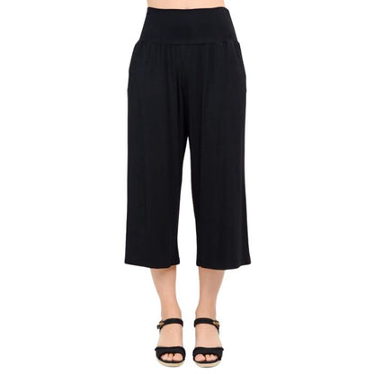 female model wearing black gaylene capri pants front view on white background