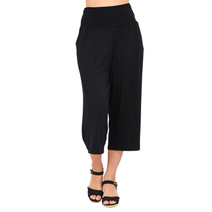 female model wearing black gaylene capri pants front view on white background