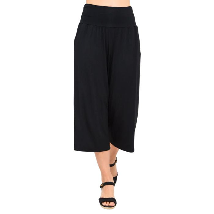 female model wearing black gaylene capri pants front view on white background