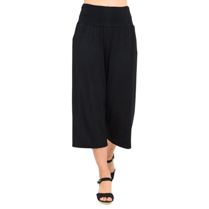 female model wearing black gaylene capri pants front view on white background