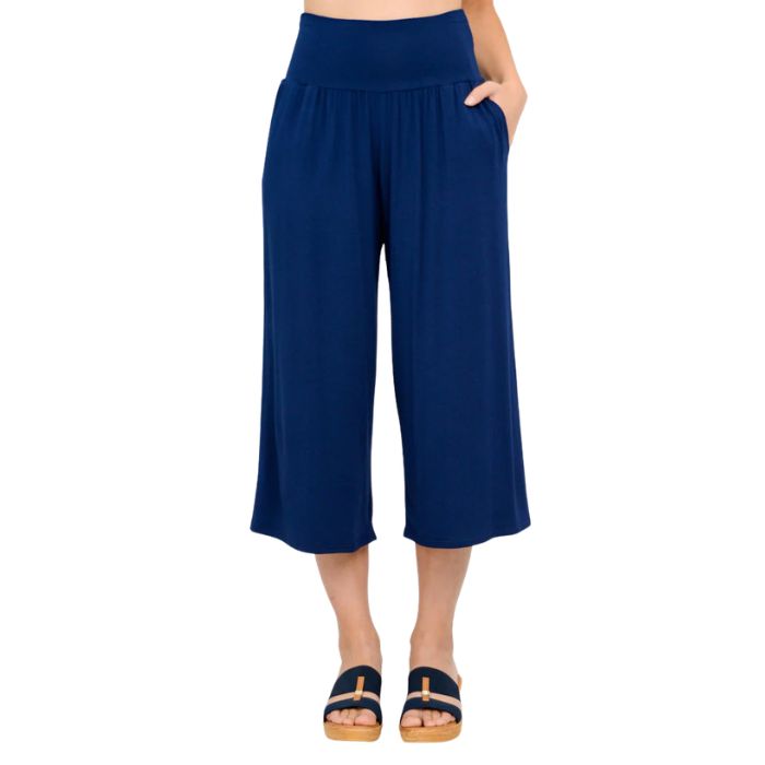 female model wearing indigo blue gaylene capri pants front view on white background