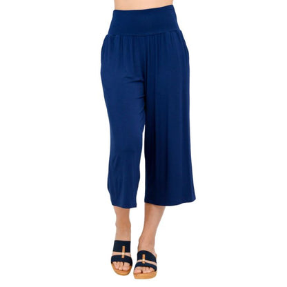 female model wearing indigo blue gaylene capri pants front view on white background