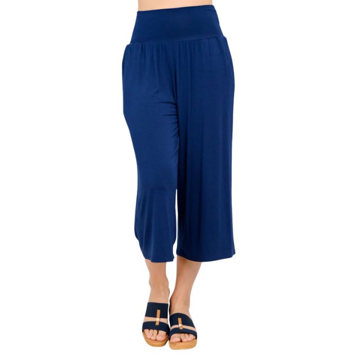 female model wearing indigo blue gaylene capri pants front view on white background