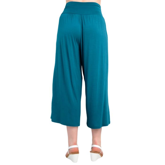 female model wearing teal green gaylene capri pants back view on white background