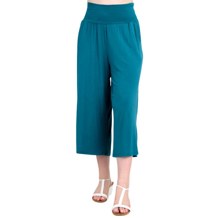 female model wearing teal green gaylene capri pants front view on white background