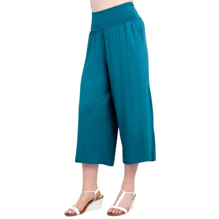 female model wearing teal green gaylene capri pants side view on white background