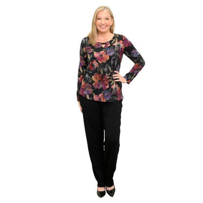 a woman wearing pink petals print gemi top and black norma pants front view on white background