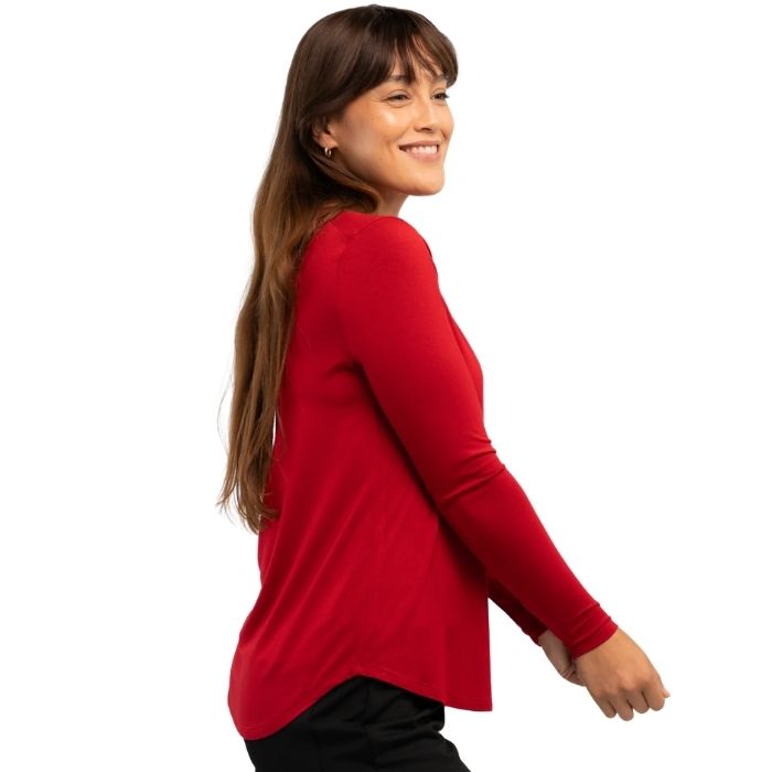 female model wearing ruby red georgia crew top side view on white background