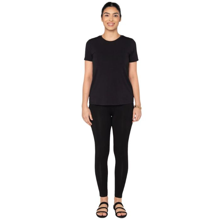 top of female model wearing black gracie crew neck t-shirt and black terry leggings front view on white background