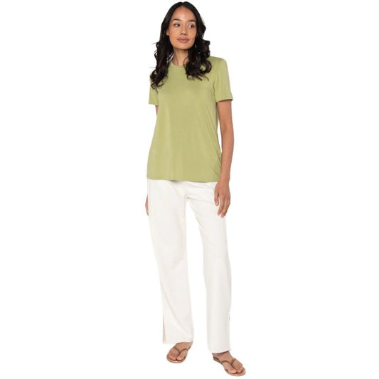 female model wearing cirton green gracie crew neck t-shirt and cream white cora pants front view on white background