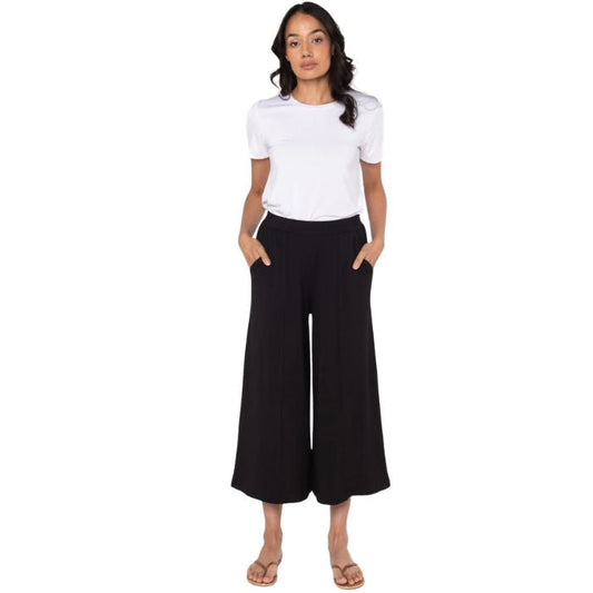 female model wearing white gracie crew neck t-shirt and black pauline culotte pants front view on white background