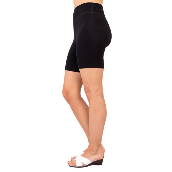 female model wearing black hallie shorts side view on white background