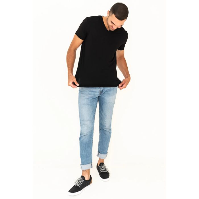 male model wearing black huron v-neck t-shirt back and blue jeans front view on white background