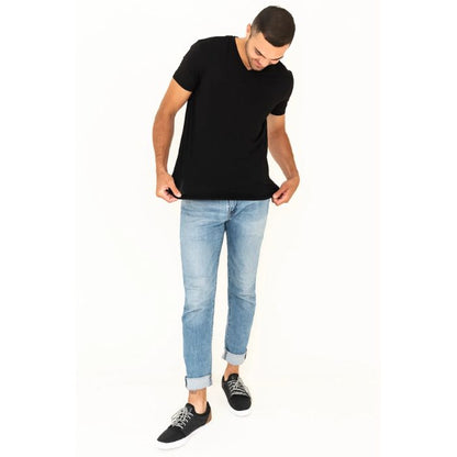 male model wearing black huron v-neck t-shirt back and blue jeans front view on white background