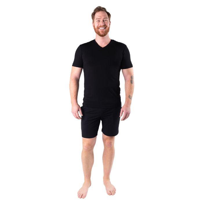 male model wearing black huron v-neck t-shirt and black aspen shorts front view on white background