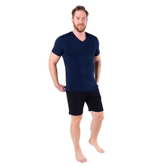 male model wearing ink blue huron v-neck t-shirt and black aspen shorts front view on white background