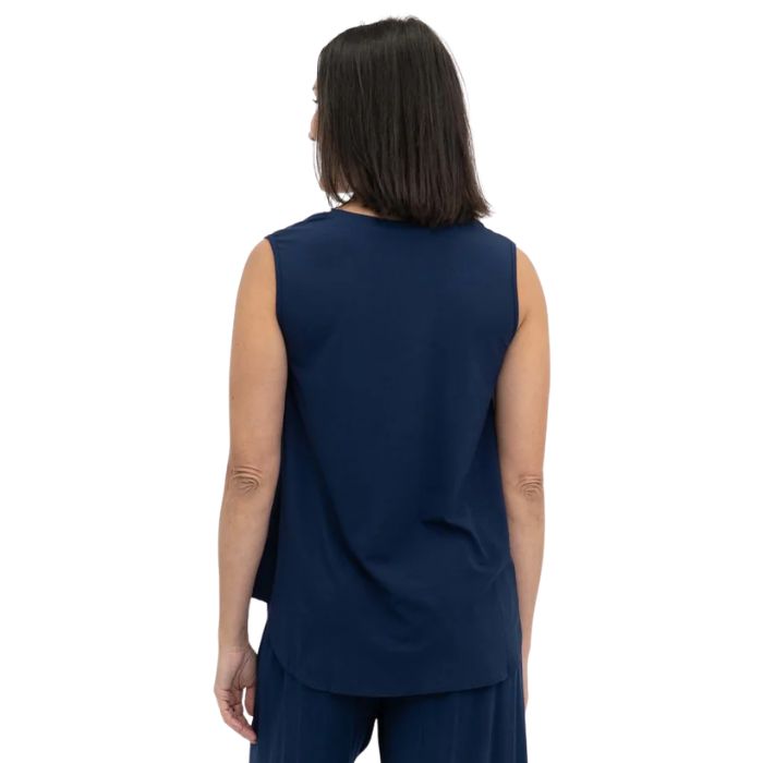 female model wearing indigo blue jackie tank top back view on white backround