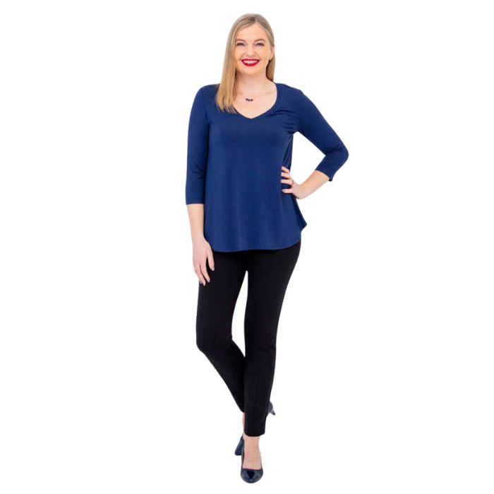 female model wearing indigo blue jackie top and black nadia pants front view on white backround
