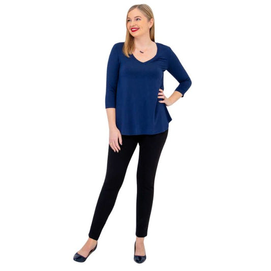female model wearing indigo blue jackie top and black nadia pants front view on white backround