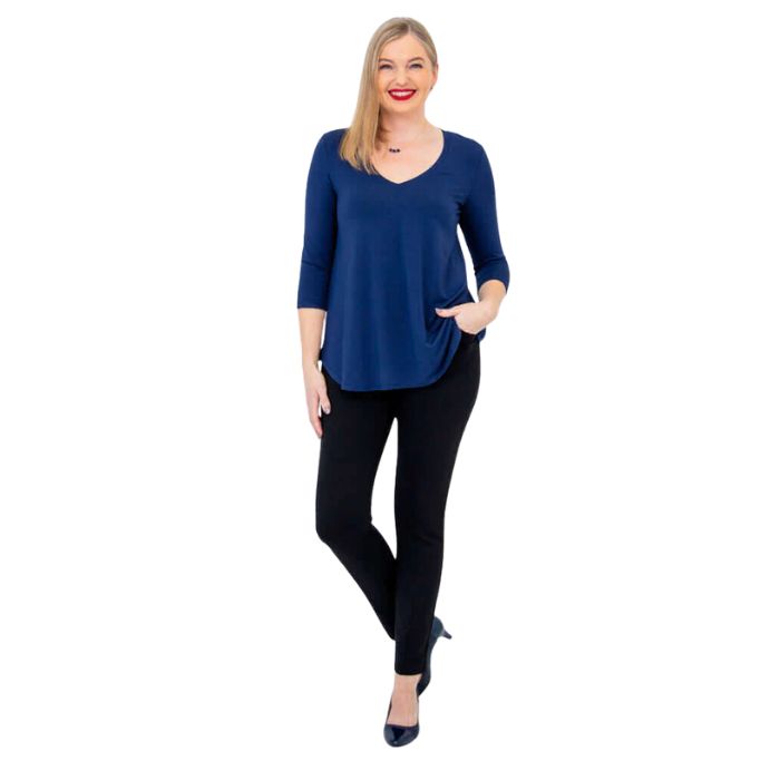 female model wearing indigo blue jackie top and black nadia pants front view on white backround