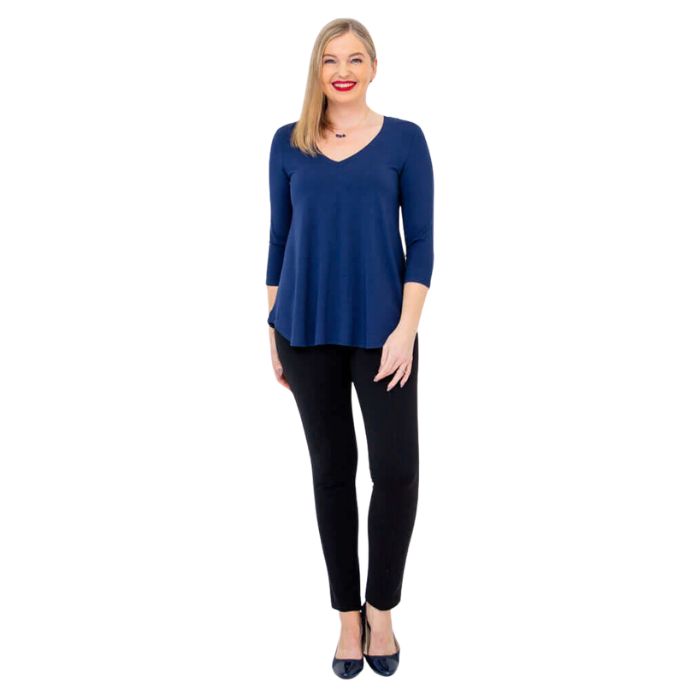 female model wearing indigo blue jackie top and black nadia pants front view on white backround