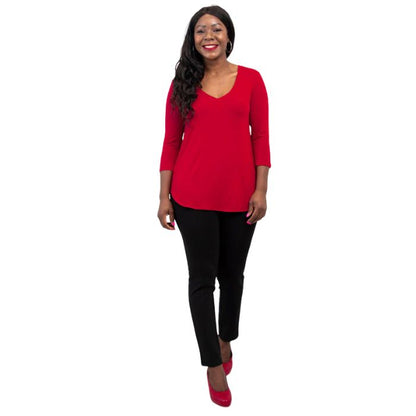 female model wearing lipstick red jackie top and black nadia pants front view on white backround