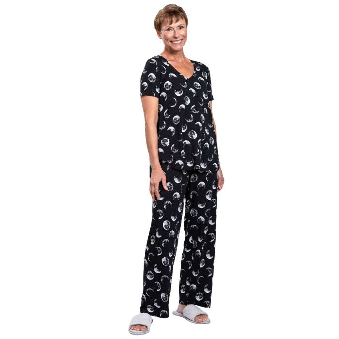 female model wearing moonstruck print jackie top and moonstruck print dream pants front view on white backround