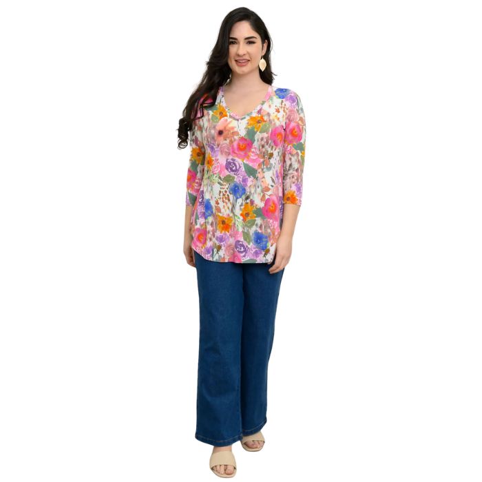female model wearing pink bouquet print jackie top and denim blue jeans front view on white backround