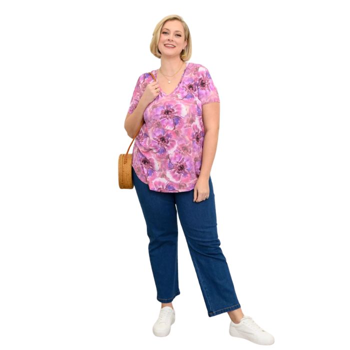 female model wearing royale cardiff print jackie top and denim blue jeans front view on white backround