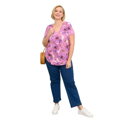 female model wearing royale cardiff print jackie top and denim blue jeans front view on white backround