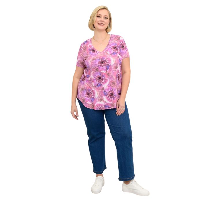 female model wearing royale cardiff print jackie top and denim blue jeans front view on white backround