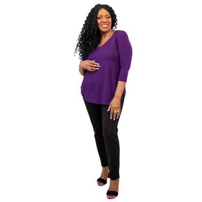 female model wearing royale purple jackie top and black nadia pants front view on white backround