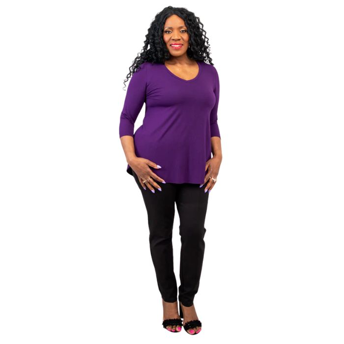 female model wearing royale purple jackie top and black nadia pants front view on white backround